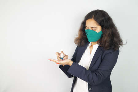 Girl Wearing Mask In Office ,  face mask , using sanitizer images .の写真素材
