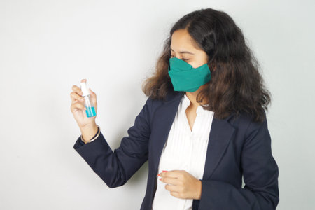 Girl Wearing Mask In Office ,  face mask , using sanitizer images .の写真素材