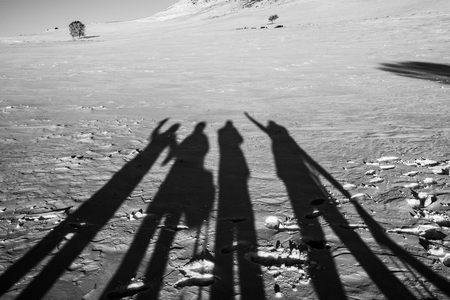 Shadow of people on snowfieldの写真素材
