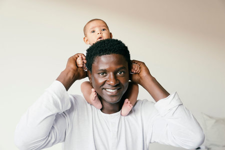 Happy father piggybacking his baby. Family conceptの写真素材