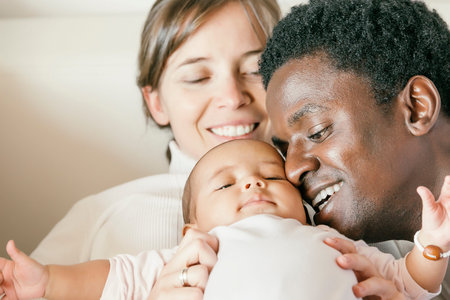 Happy Family, Mother, Father And Baby on Bed