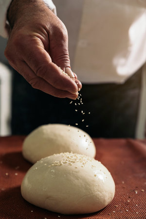 Baker kneading dough in a bakery. Bakery Concept.