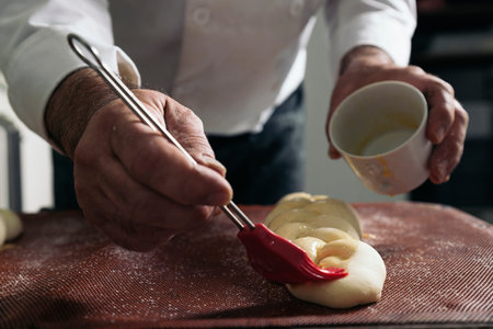 Baker kneading dough in a bakery. Bakery Concept.