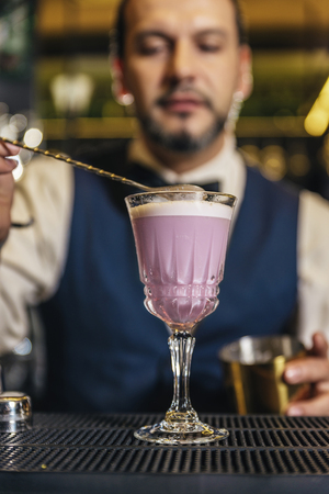 Expert barman is making cocktail at night clubの写真素材