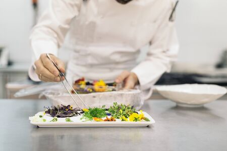 Male professional chef cooking in a kitchen.の写真素材