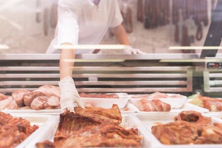 Pretty Butchery Woman working in butchery shop.の写真素材