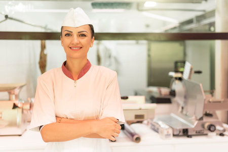Pretty Butchery Woman working in butchery shop.の写真素材
