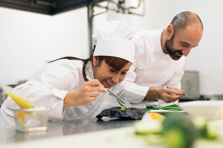Two professionals chefs cooking together in a kitchen.