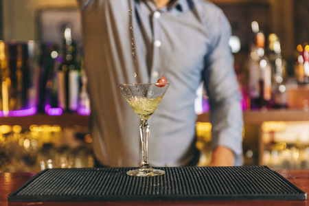 Expert barman is making cocktail at night club.の写真素材