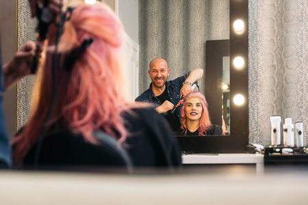 Beautiful woman getting haircut by hairdresser in the beauty salón.の写真素材