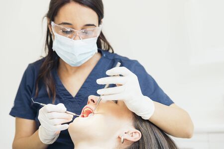 Dentists with a patient during a dental intervention.の写真素材