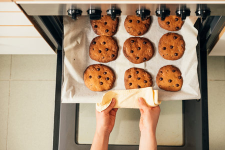 Beautiful woman Preparing Cookies And Muffins at Home.の写真素材