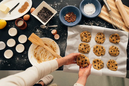 Beautiful woman Preparing Cookies And Muffins at Home.の写真素材