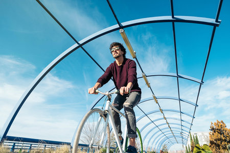 Outdoor portrait of handsome young man with fixed gear bicycle in the street.の写真素材