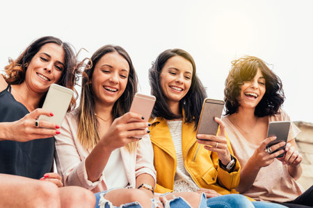 Big Group of friends using cellphones in the street.