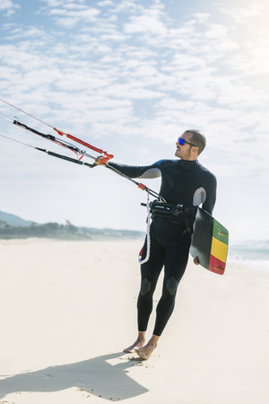 Portrait of handsome man kitesurfer in the beach.の写真素材