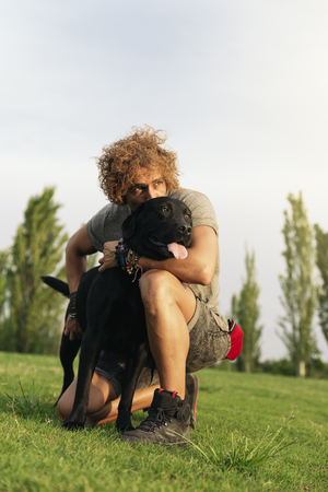 Man having fun and playing with his dog in the park.の写真素材