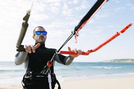 Portrait of handsome man kitesurfer in the beach.の写真素材