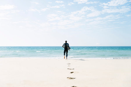 Handsome man kitesurfer running in the beach.の写真素材