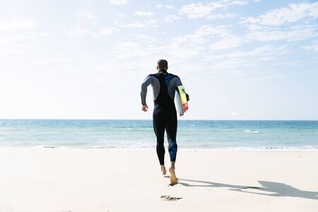 Handsome man kitesurfer running in the beach.の写真素材