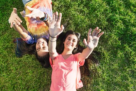 Beautiful Teenage Girls Having Fun in Summer Park. Outdoorsの写真素材