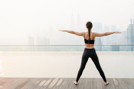 Relaxed young yoga woman in yoga pose near pool. Yoga Concept.の写真素材