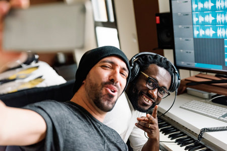 Multiracial artists taking a selfie with mobile while produce music.の写真素材