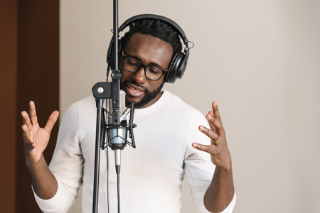 African young man singing on musical studio.の写真素材