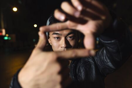 Portrait of a asian young man in the city.の写真素材