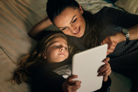 Mother and her child with digital tablet relaxing at home. Family Concept.の写真素材