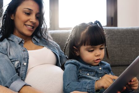 Happy family using tablet at home.の写真素材