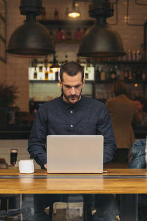 Businessman using his laptop in the Coffee Shop. Business Concept.の写真素材