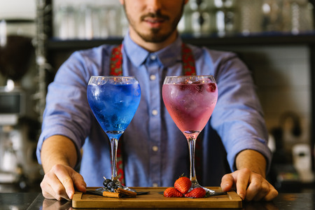 Expert barman is making cocktail at night club.の写真素材