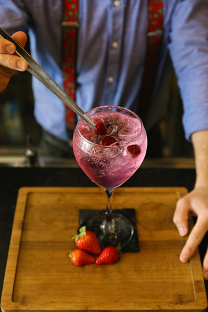 Expert barman is making cocktail at night club.の写真素材