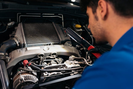 Professional Mechanic Repairing Car Engine in Garage.