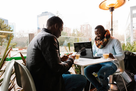 Business men using mobile and laptop in the coffee shop. Business Concept