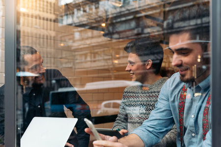 Friends drinking coffee and chatting in cafe.の写真素材