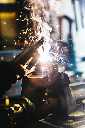Mechanic man welding metal material in garage. Mechanic Concept.の写真素材