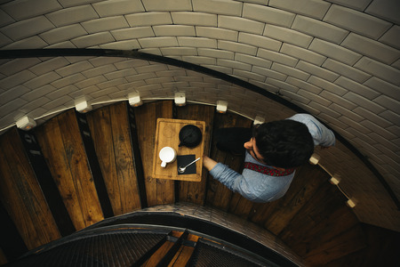 Waiter holding a tray with coffees in the bar.の写真素材