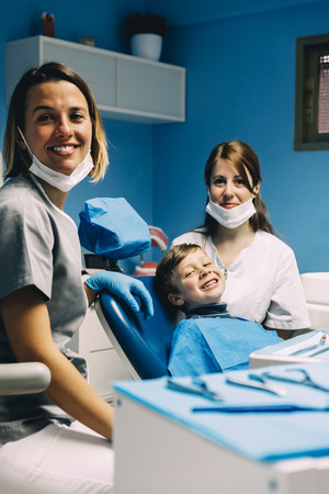 Portrait of dentists and child patient in dental clinic. Dental Clinic concept.の写真素材