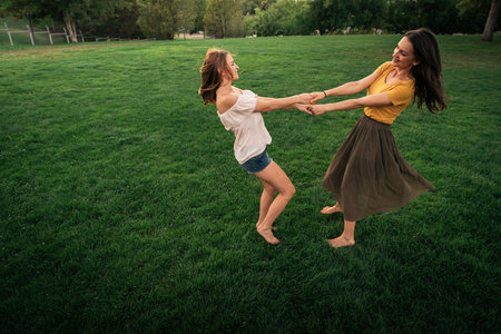 Beautiful women smiling and having fun in the park. Friends and summer concept.の写真素材