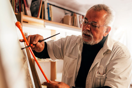 Old man artist painting oils in his studio. Artist Concept.の写真素材