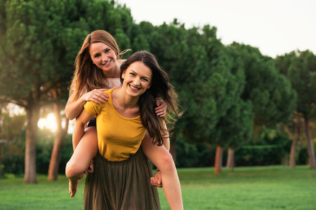 Beautiful women having fun in the park. Friends and summer concept.