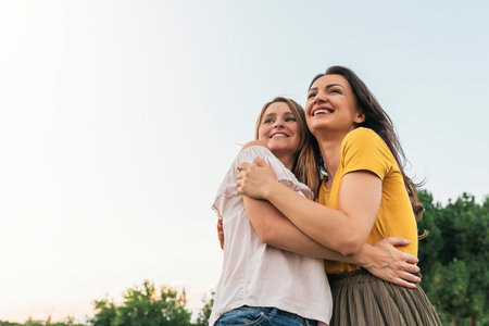 Beautiful women smiling and having fun in the park. Friends and summer concept.の写真素材
