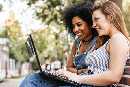 Beautiful women using a laptop in the Street. Youth concept.の写真素材
