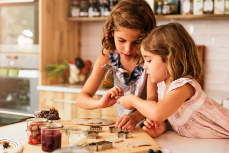 Little sisters girl preparing baking cookies. Infant Chef Concept.の写真素材
