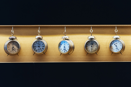 Vintage alarm clock on wood background. Time Concept.の写真素材