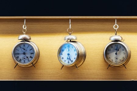 Vintage alarm clock on wood background. Time Concept.の写真素材