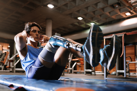 Disabled young man training in the gym. Disabled sportsman Concept.の写真素材