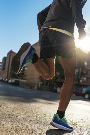 Close up of legs of runner in the city. Fitness, workout, sport, lifestyle concept.の写真素材